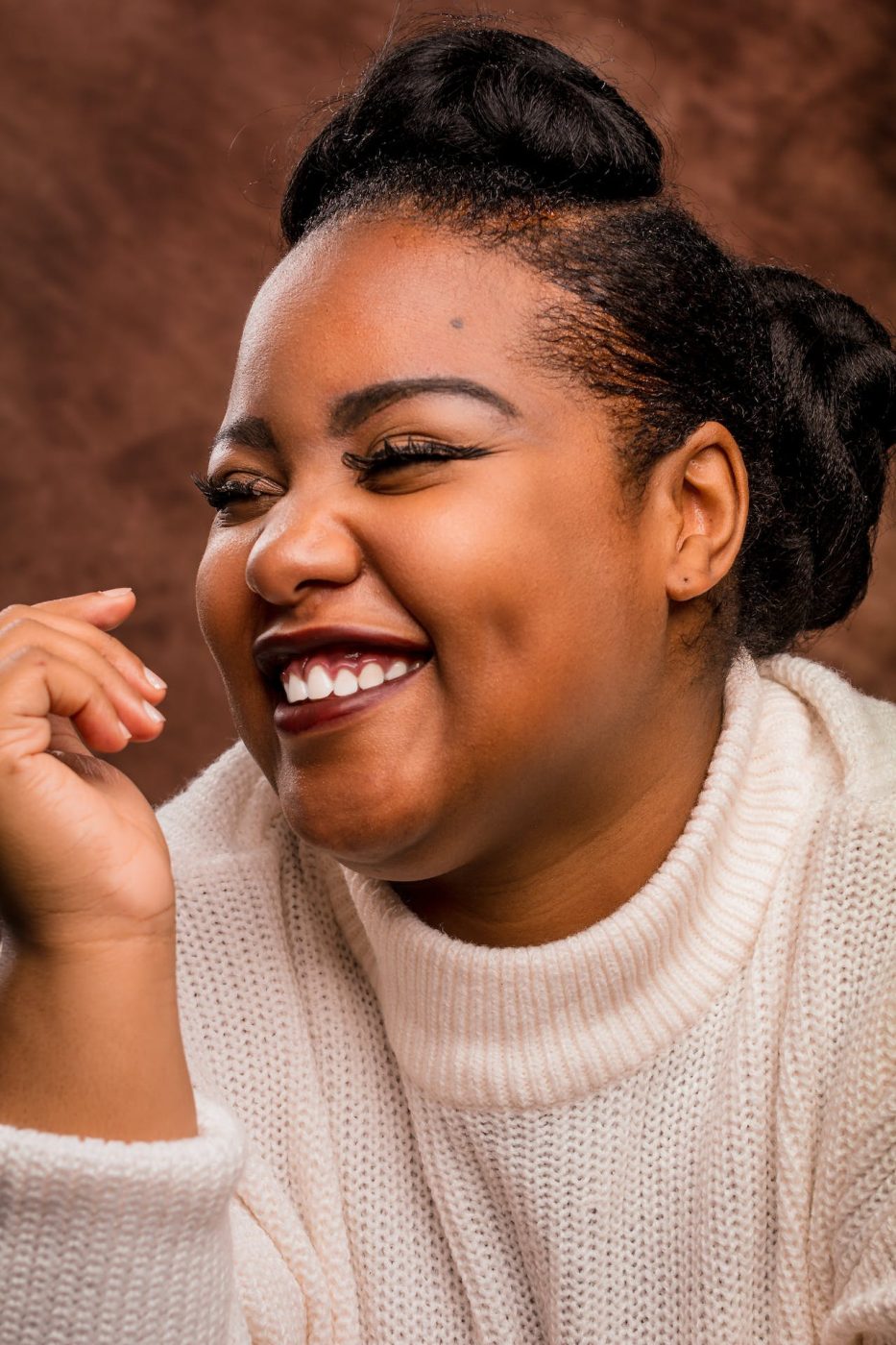 woman of color smiling and happy that she enhanced her vision after LASIK